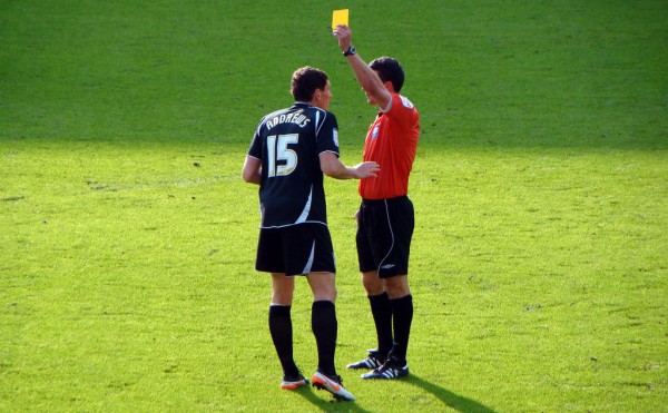 Yellow card given by referee to footballer